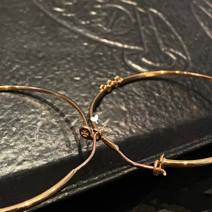 KLX-964244 light gold spear flower cross hoop earrings
